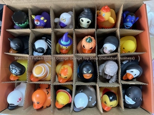 Detailed view of 24 unique Halloween rubber ducks in a compartmentalized storage box