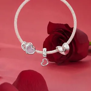 925 sterling silver heart charm bracelet with pink stones on a red rose background