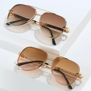 Classic pilot rimless sunglasses with gradient lenses and gold metallic frame on white props
