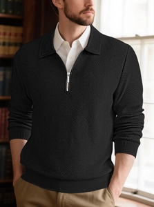 Close-up of black men's knit sweater featuring detailed jacquard diamond textures