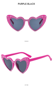 Detail of pink heart sunglasses with sparkling rhinestones and star accents