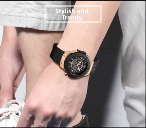 Close-up of a men's waterproof sport watch with rose gold case and black silicone strap
