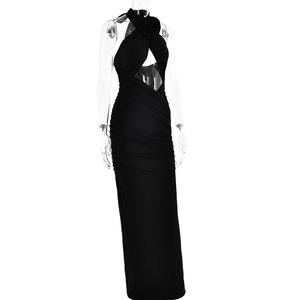 Detail of a black halter maxi dress featuring 3D flower neckpiece and sexy cut-out design