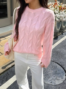 Pink cable knit long sleeve crewneck sweater for women in casual outdoor street setting