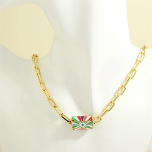 Detail of gold evil eye pendant with colorful enamel and trendy paperclip chain