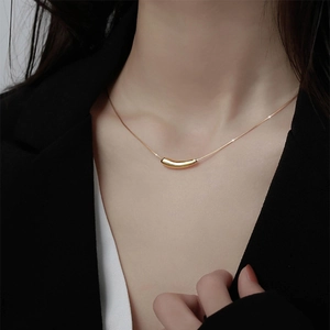 Minimalist 18K gold plated stainless steel necklace with a curved tube pendant on a model