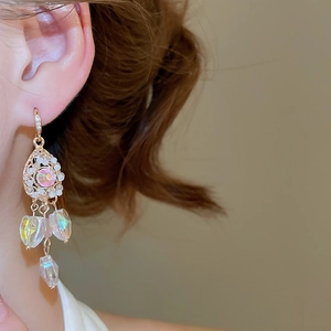 Macro detail of French vintage water drop earrings with iridescent crystals and beads