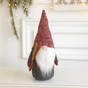 Plush Christmas gnome with red knit hat, white beard, and wooden skis decoration