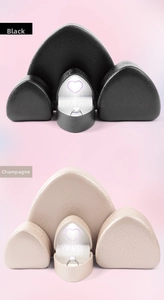 Macro detail of heart-shaped LED ring boxes in black and champagne with purple light glow
