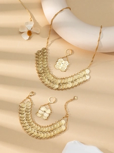 Detail of 24k gold-plated double-row coin bracelet featuring textured vintage discs