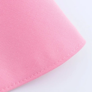 Macro shot of pink tube top showing fine fabric texture and durable overlock stitching