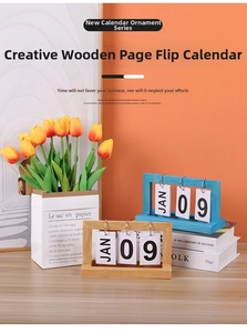 Detail of wooden flip calendar with blue and natural wood frames on a vibrant desk
