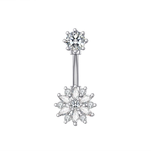 Macro detail of silver navel ring featuring sparkling floral zircon and round gemstone