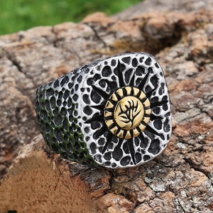 Classic men's two-tone wide ring with floral relief on rustic wood bark background