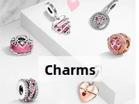 Close-up of heart-shaped DIY charm beads with pink zircon and red enamel details