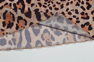 Detail shot of leopard print fabric showing the fine lettuce edge hem and double-sided print