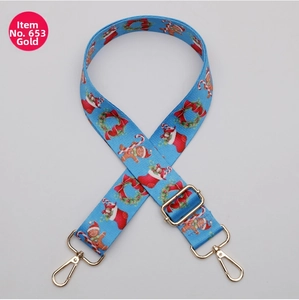 Detail of adjustable blue Christmas crossbody bag strap with golden metal hardware