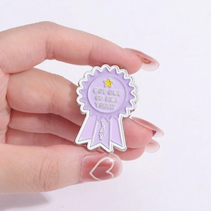 Purple enamel award medal pin with Got Out Of Bed Today slogan and yellow star