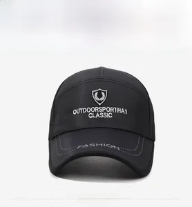 Close-up of black breathable mesh trucker hat with silver shield embroidery and curved brim