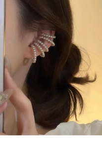 Close-up of elegant French vintage multi-layer pearl ear cuff on a female model's ear