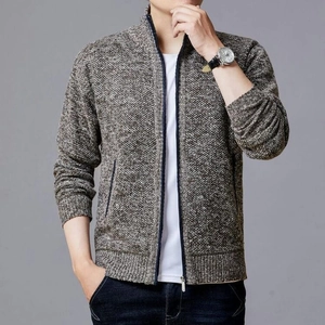 Detailed close-up of a brown knit zip-up cardigan showing heavy texture and quality fabric