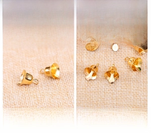 Detailed macro shot of golden DIY Christmas bell accessories on fabric