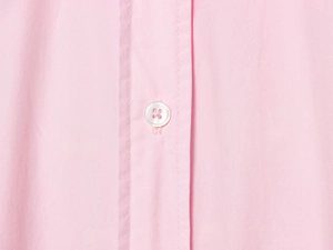 Detail view of pink cotton poplin shirt featuring white buttons and fine stitching