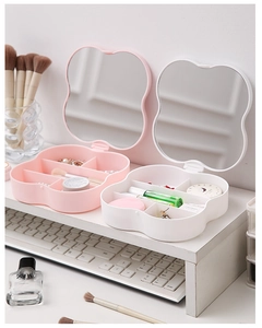 Detail of flower-shaped cosmetic storage box with internal dividers and lid mirror