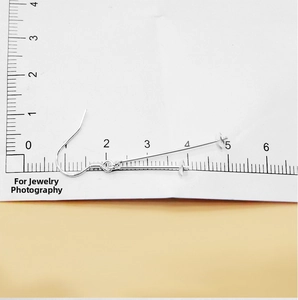 Detailed view of S925 sterling silver ear hooks with pins measured on a scale card