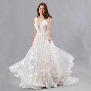 Elegant white deep V-neck bridal gown featuring floral embroidery and mesh A-line skirt