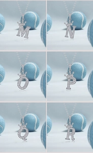 Detail of silver letter pendants M to R with moissanite pave and crown crown decor