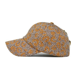 Detailed knit texture of a brown leopard print ponytail baseball cap with adjustable strap
