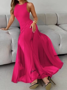 Detail of elegant magenta sleeveless dress showing layered mesh fabric and side slit hemline
