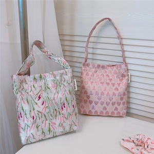 Detail of pink floral and heart jacquard tote bags with matching hair scrunchie