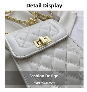 Detailed macro view of white quilted leather texture and gold metal clasp on crossbody bag