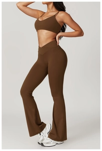 Detail of high waisted V-shaped crossover waistband on dark brown yoga flare pants