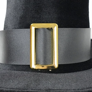 Macro detail of high top hat featuring a golden metal buckle and black leather band
