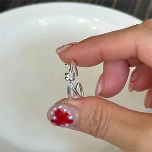 Macro shot of silver-colored knot design ear cuff crafted from polished S925 sterling silver