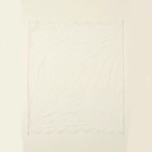 Detail shot of breathable white floral lace fabric with delicate scalloped edges