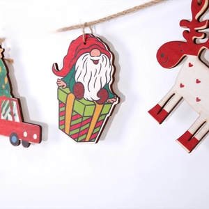 Detail view of festive wooden Christmas gnome and reindeer hanging decorations with jute rope