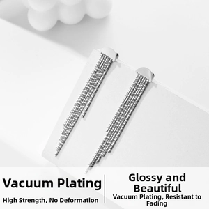 Close-up of silver long tassel earrings with snake chain and vacuum plating texture