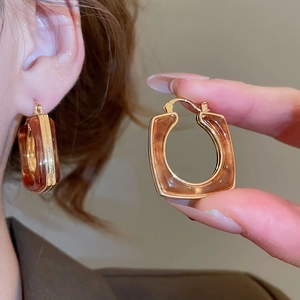 Detailed macro of 18k gold plated resin square hoop earring with vintage tortoiseshell texture