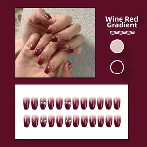 Detail of burgundy ombre coffin nails with silver metallic cross accents and 24pc set