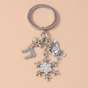 Close-up of silver Christmas keychain with deer, Santa Claus, and snowflake pendants