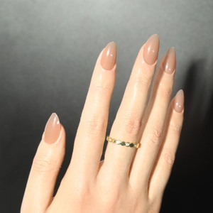 Golden honeycomb hexagon ring with white zircon stones worn on model's finger