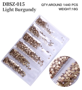 Macro detail of Light Burgundy flatback nail rhinestones in a compartment organizer