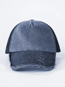 Detail of washed denim trucker hat with distressed brim and breathable black mesh