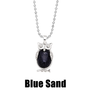 Detailed close-up of retro owl pendant with Blue Sand stone on silver chain
