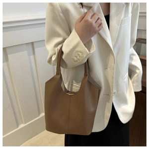 Detail of premium brown lychee pattern leather bucket bag with vertical stitching craftsmanship