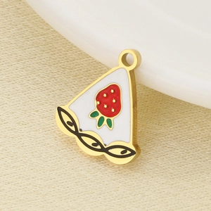 Macro shot of a golden strawberry cake slice charm pendant with red enamel finish